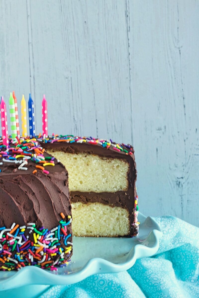 Yellow birthday cake with chocolate frosting.