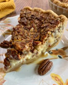 A slice of pecan cheesecake pie on a fall dessert plate