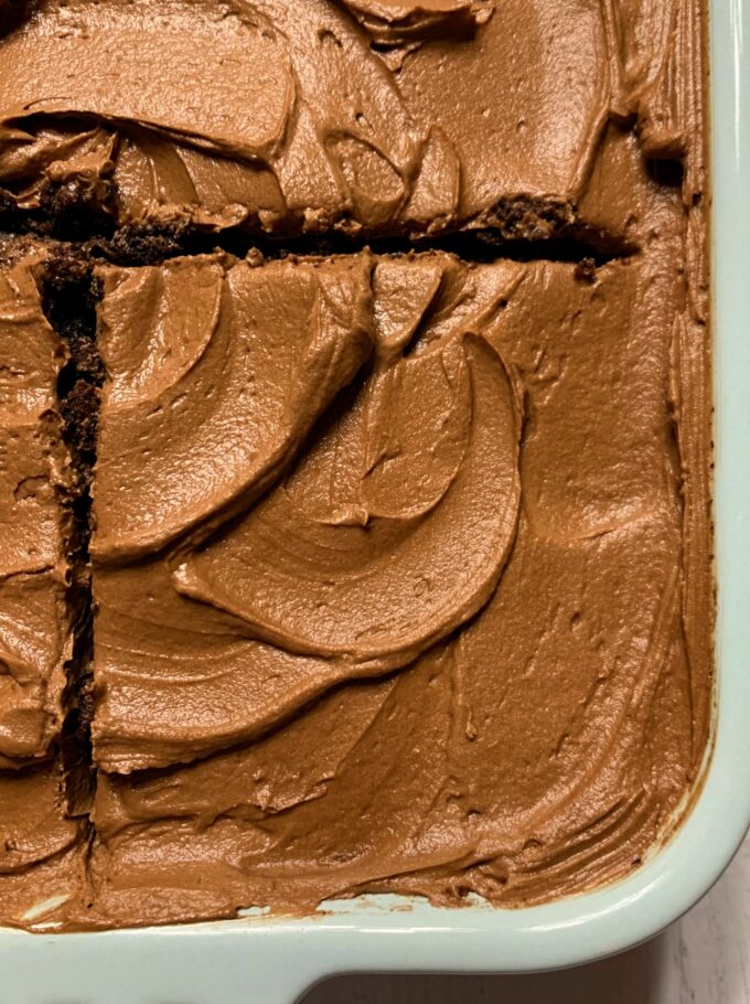 A chocolate cake with chocolate frosting in a baking dish.