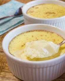 White ramekins with baked egg custard.