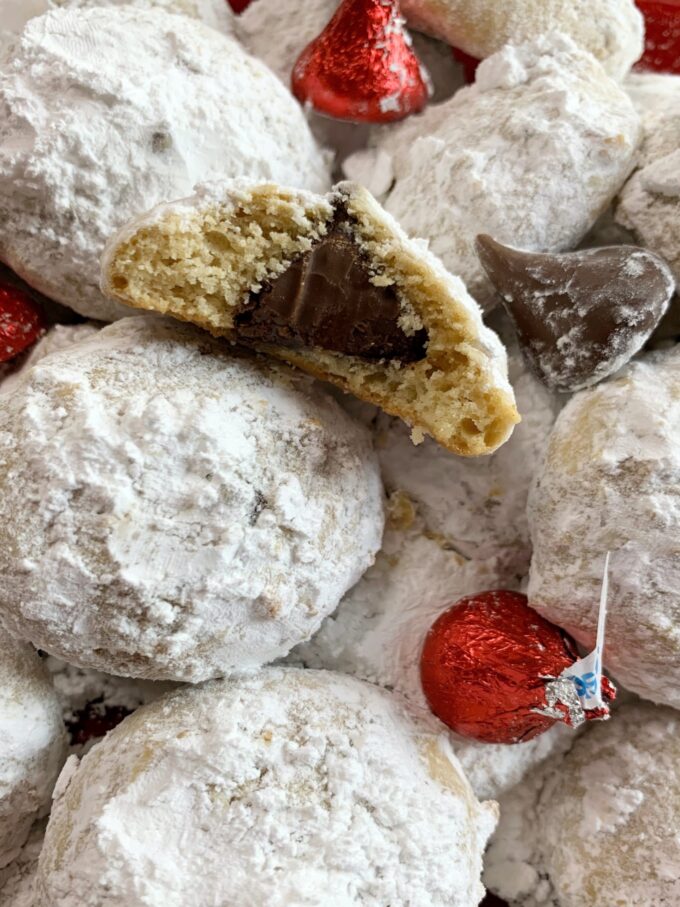 Hidden Kiss Cookies. Soft cookies with a kiss hidden in the middle. They are dipped in powdered sugar.