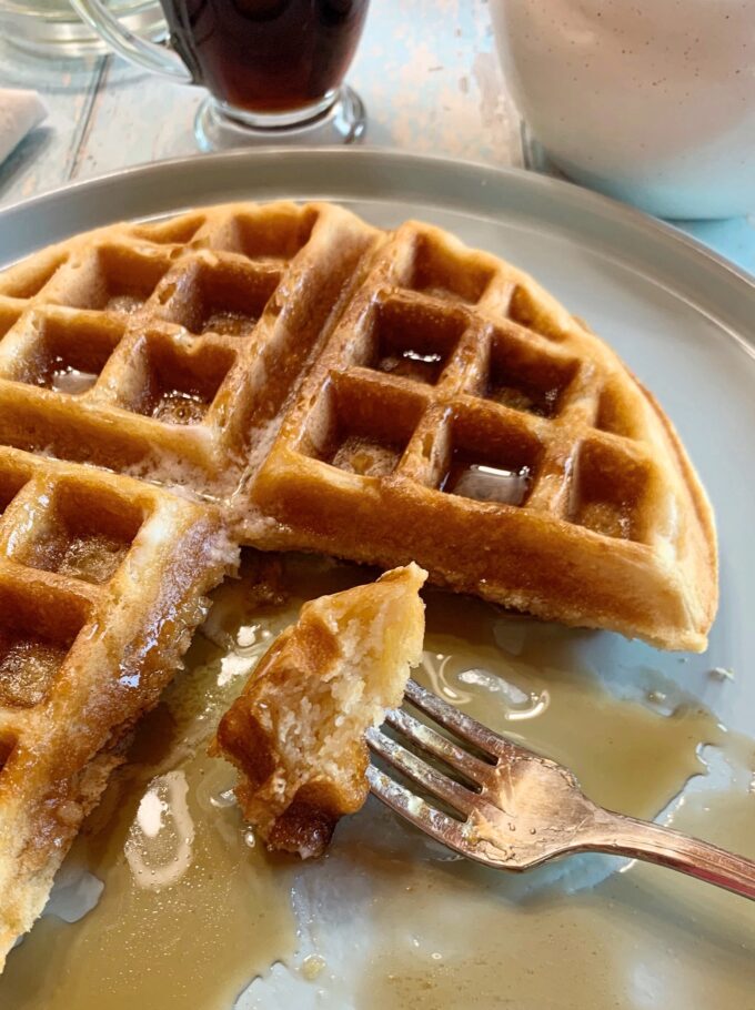 A Buttermilk Waffle with a bite on a fork.