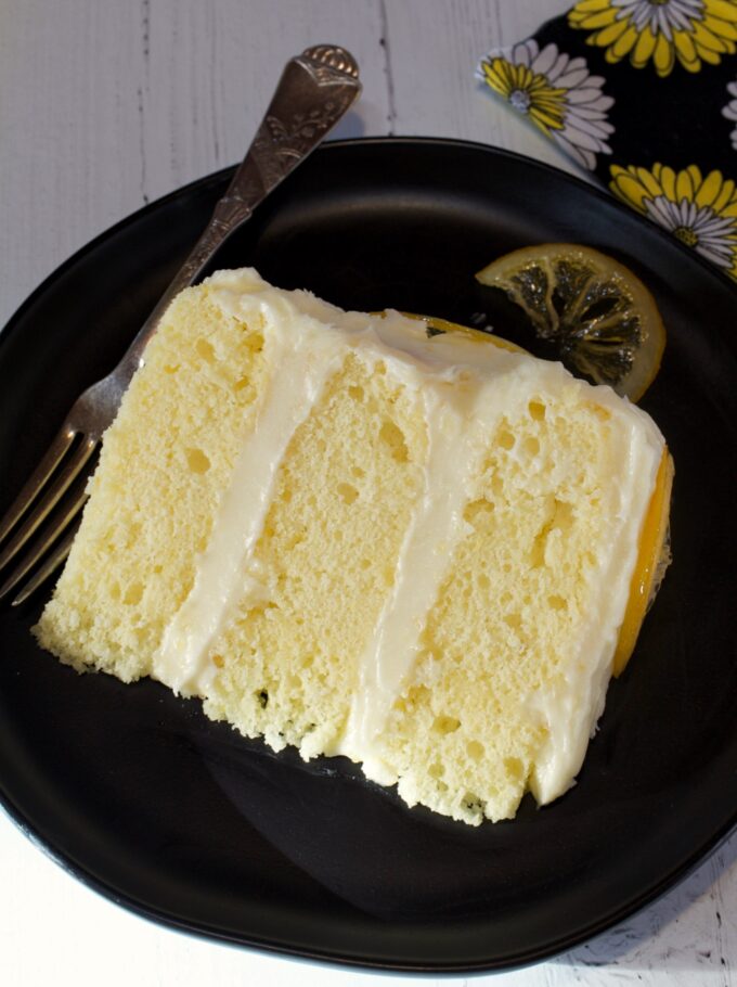 A slice of Lemon Layer Cake with Buttercream Frosting.