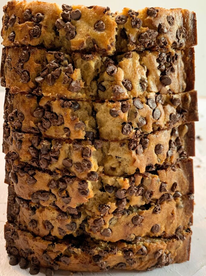 A sliced loaf of chocolate chip banana bread standing vertically on one end.