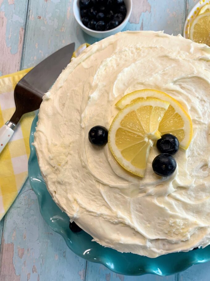 A Lemon Blueberry Cake on a blue dessert plate.