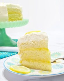 A slice of Lemon Chiffon Layer Cake on a dessert plate.