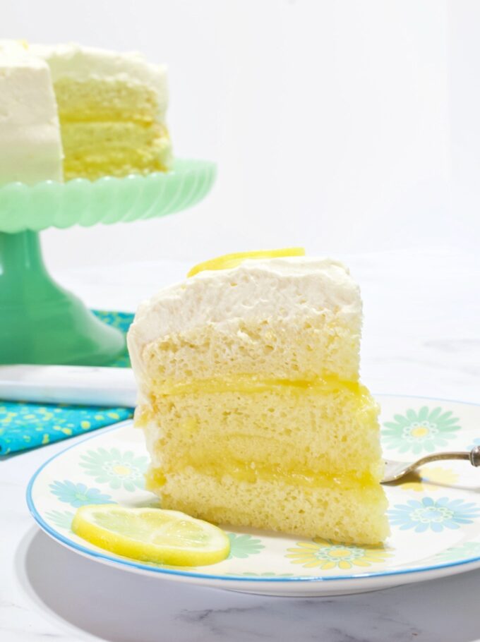 A slice of Lemon Chiffon Layer Cake on a dessert plate.