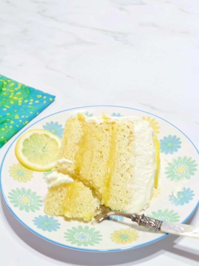 A slice of Lemon Chiffon Cake with a forked bite.