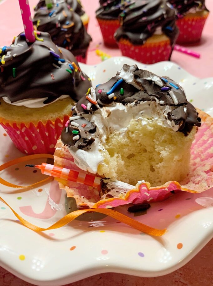 A Birthday Party Cupcake with a bite taken out.