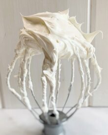 A whisk full of Swiss Meringue Buttercream.