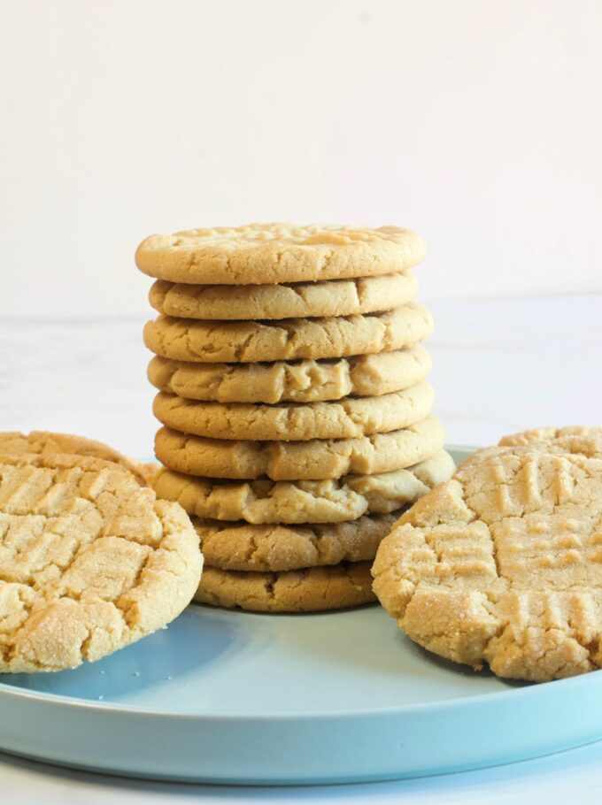 A stack of peanut butter cookies on a plate.