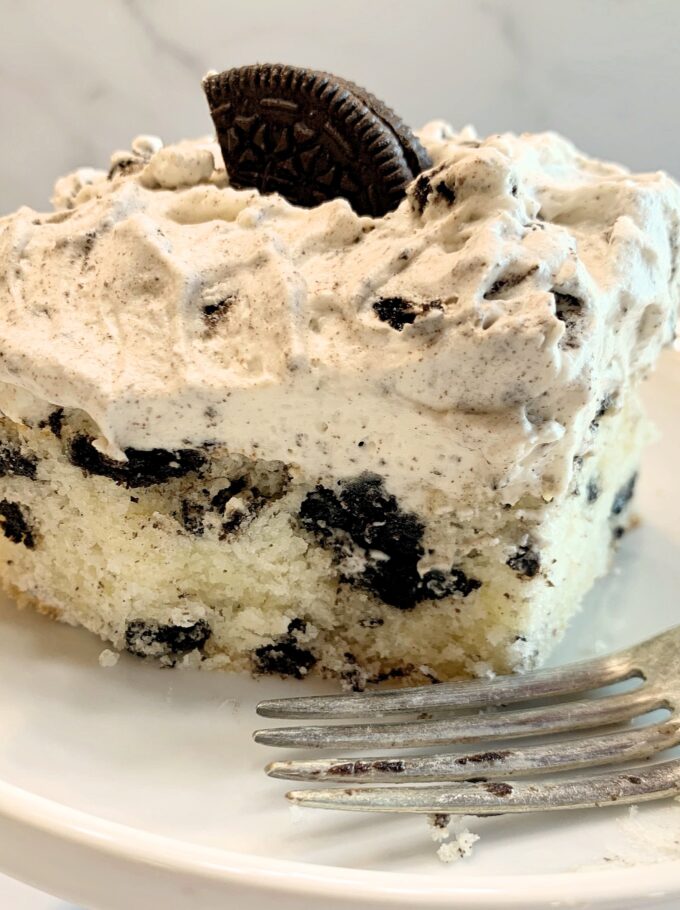 A piece of Cookies and Cream cake on a plate.