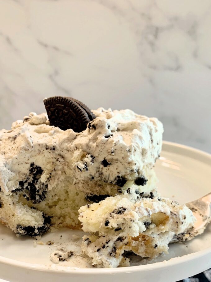 A piece of Cookies and Cream sheet cake with a forked bite.