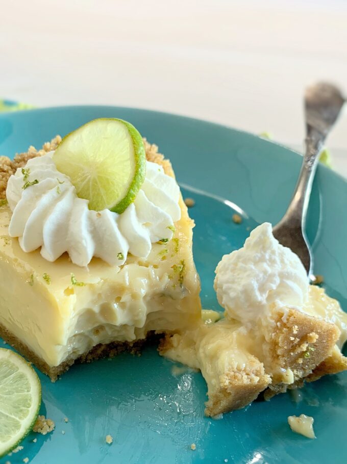 A slice of Key Lime Pie with a bite out.