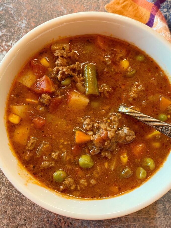An overhead view of a bowl of hamburger soup.