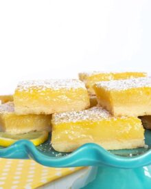 Lemon Bars on a blue dessert stand.