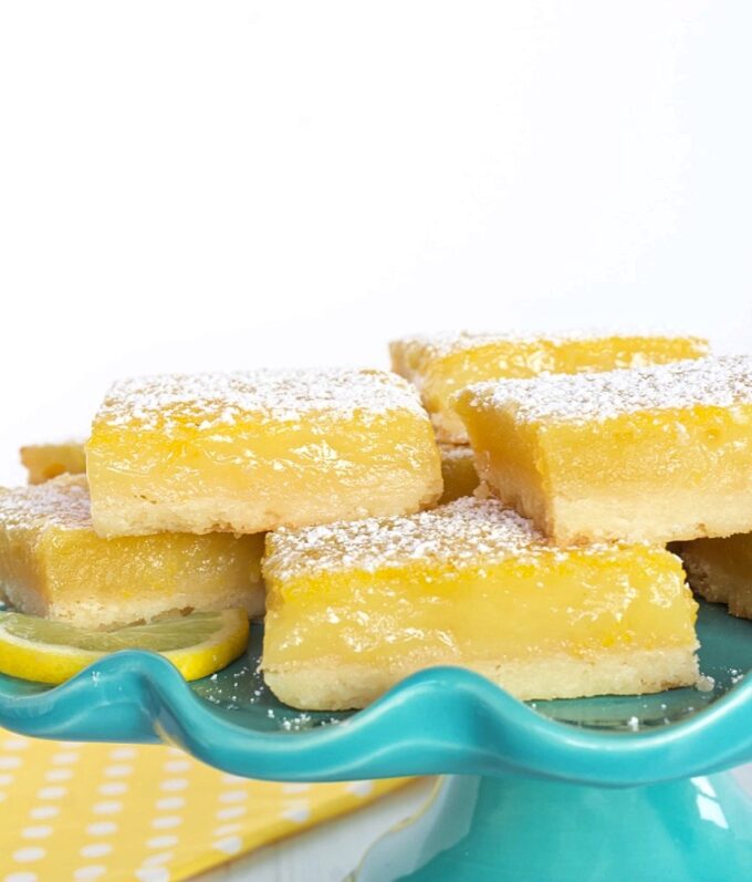 Lemon Bars on a blue dessert stand.