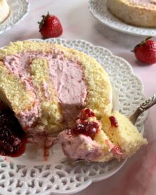 A slice of strawberry cream cake roll.