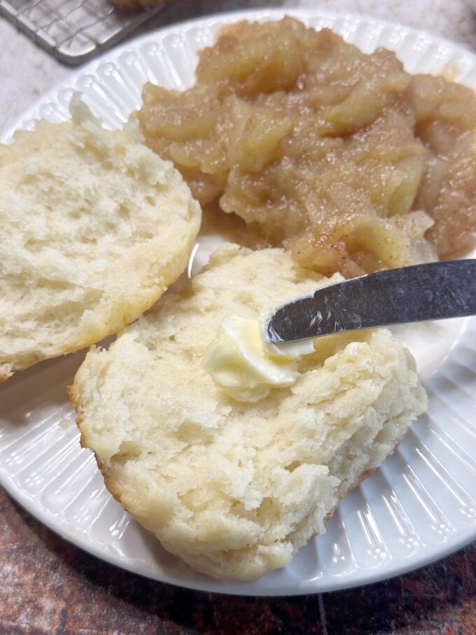 A big fluffy buttermilk biscuit with butter.