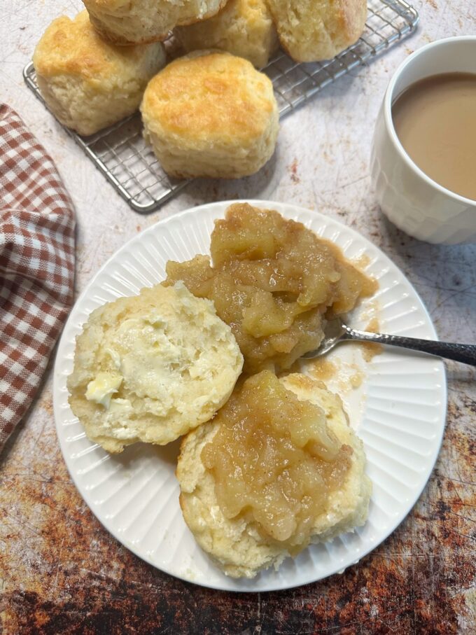 A big fluffy buttermilk biscuit with fried apples.